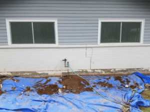 Concrete Repairman LLC technician inspecting and repairing foundation cracks and settlement issues on a residential home. Call 480-725-7614 today to schedule a professional foundation evaluation and get expert repair solutions. Concrete Repairman LLC provides trusted, durable foundation repair services tailored for Arizona homeowners.