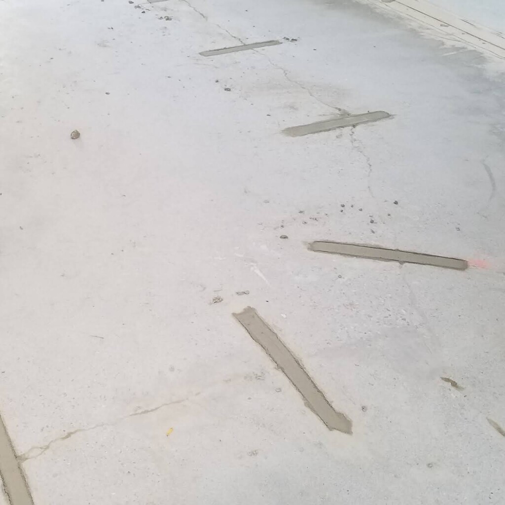 Foundation patchwork trapping moisture behind the wall, with shrinkage cracks and visible floor heave damage, professionally repaired by Concrete Repairman LLC. Call 480-725-7614 today to schedule a foundation inspection and receive expert repair for floor heave cracks and moisture-related damage. Concrete Repairman LLC provides long-term structural repair solutions designed for Arizona homes.