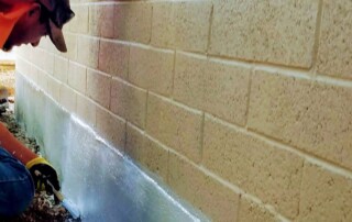 Foundation Repair Experts at Concrete Repairman LLC inspecting home foundation for cracks and structural damage. Call (480) 725-7614 for reliable repair solutions in Arizona.