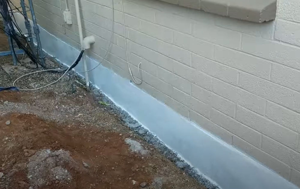 Certified technician from Concrete Repairman LLC performing foundation waterproofing on a residential home in Arizona. Call 480-725-7614 today to schedule your foundation inspection and protect your home from costly water damage and structural issues. Trust the experts at Concrete Repairman LLC for proven, professional repairs.