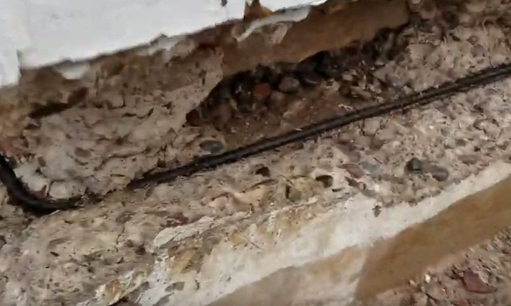 Image of a certified Concrete Repairman LLC technician using precision tools to perform engineered foundation repair on a residential property. Call 480-725-7614 today to schedule a structural inspection and receive expert repair solutions backed by engineering standards. Concrete Repairman LLC delivers trusted, science-based foundation repair across Arizona.