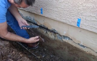 Image of a Concrete Repairman LLC specialist performing stem wall repair on a Scottsdale, Arizona home foundation. Call 480-725-7614 today to schedule a professional inspection and prevent further structural damage. Trust Concrete Repairman LLC for reliable, long-lasting foundation and stem wall repair solutions.
